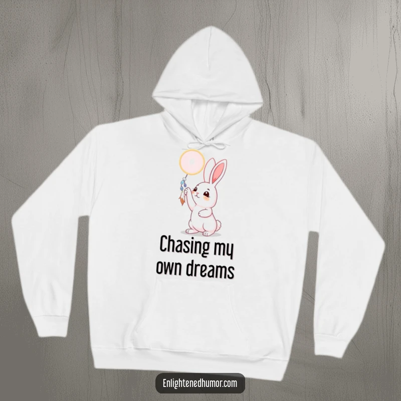 Funny rabbit hoodie design featuring a curious bunny reaching for a shimmering dreamcatcher, conveying a sense of wonder and aspiration, a cozy gift.