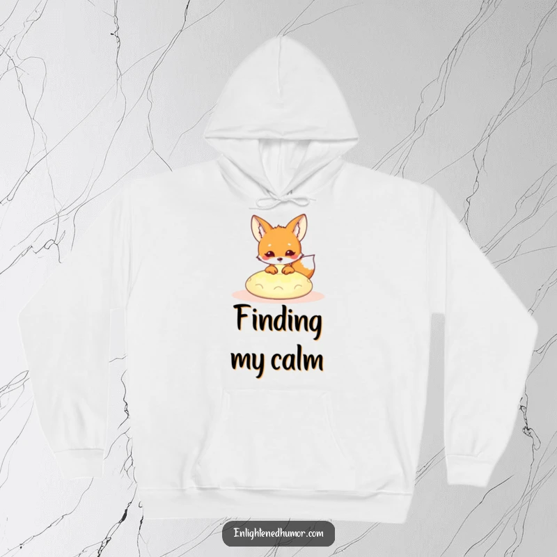 Funny Kawaii Fox Hoodie: Adorable fox peeking from a glowing meditation cushion, offering cozy humor and spiritual vibes. A great funny gift.