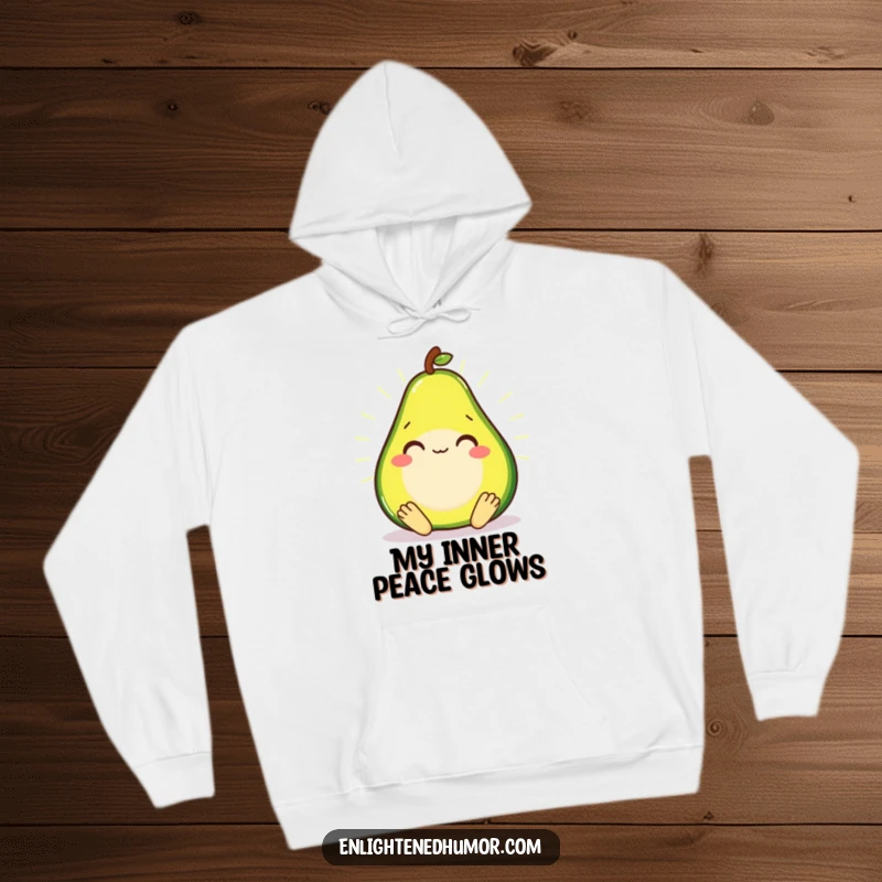 Smiling avocado in a meditative state, radiating a soft glow on a warm hoodie.